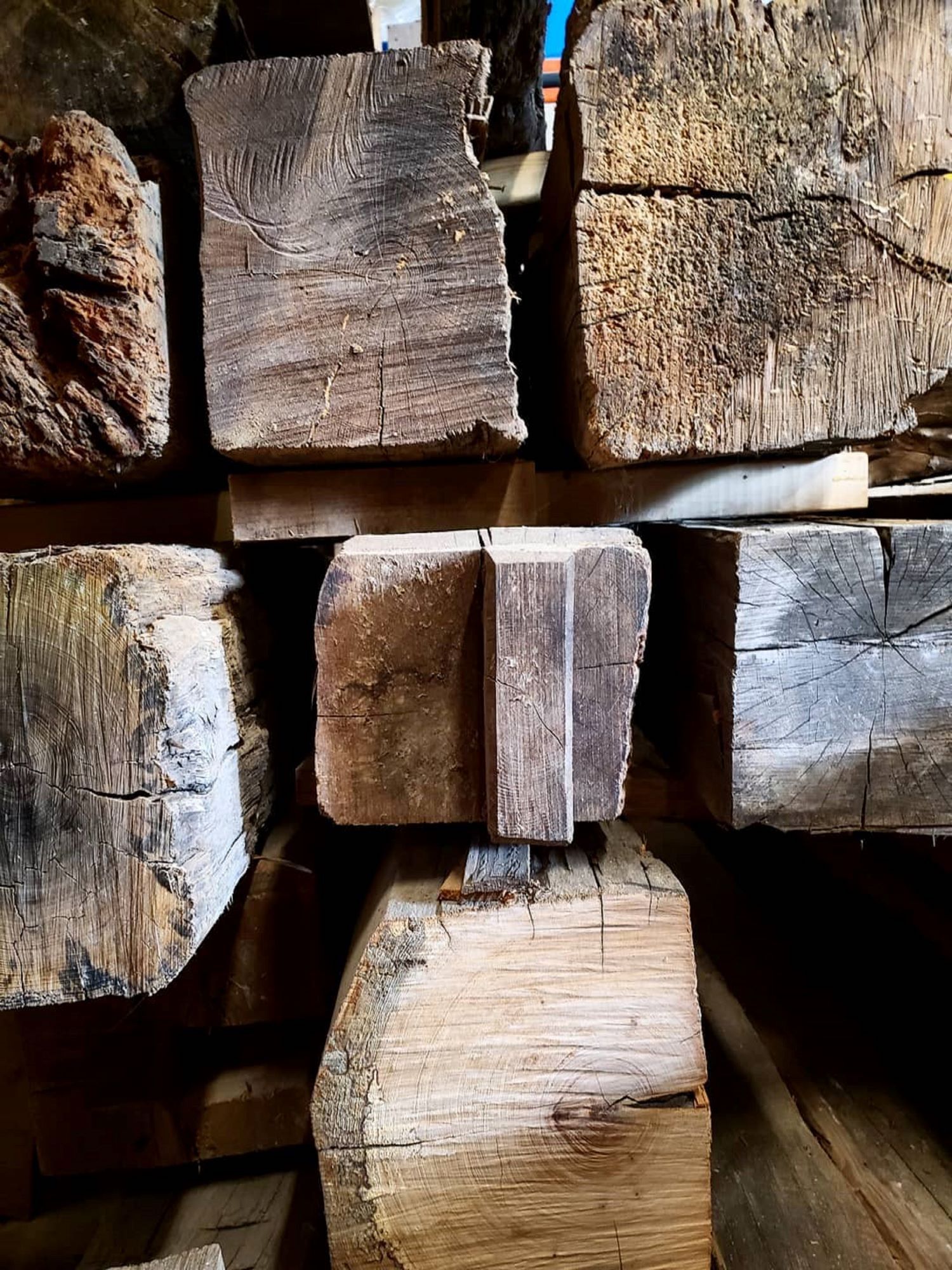 Close up view of the ends of reclaimed hand-hewn beams