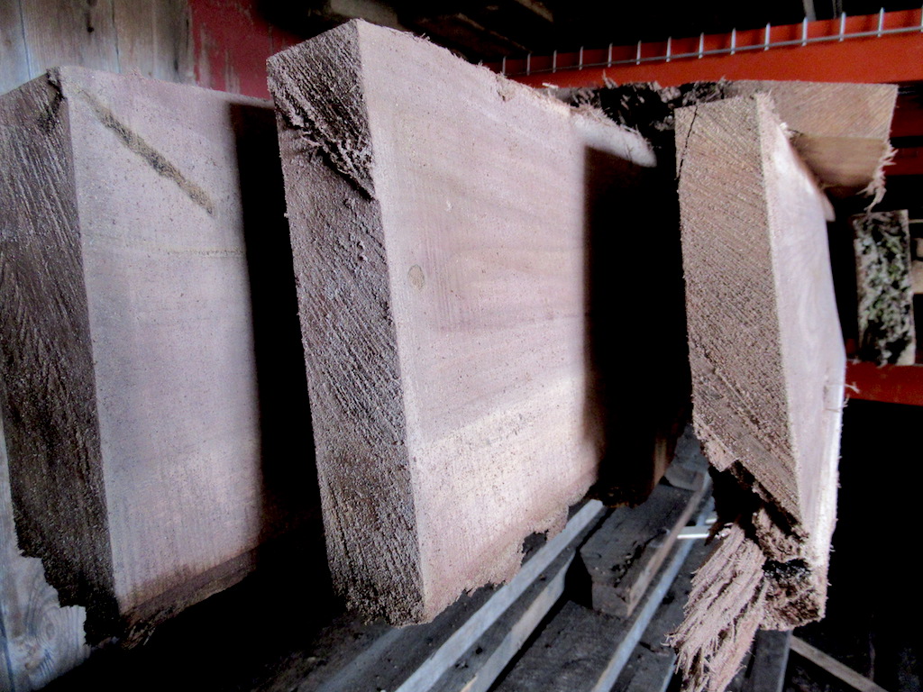 Black Walnut live edge slabs on a shelf in our warehouse